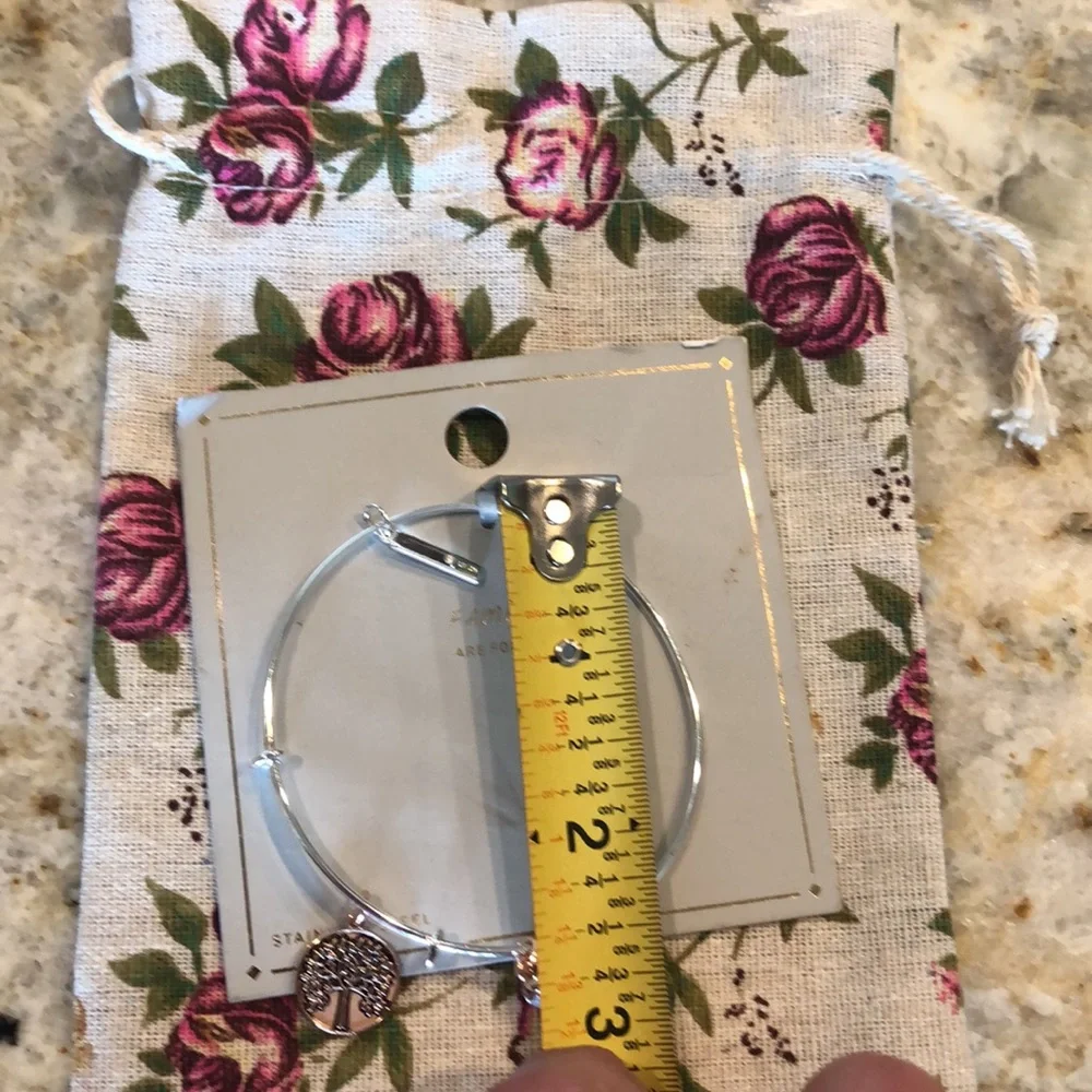 new Silver-finish bracelet with a sleek wire design and 3 hanging charms